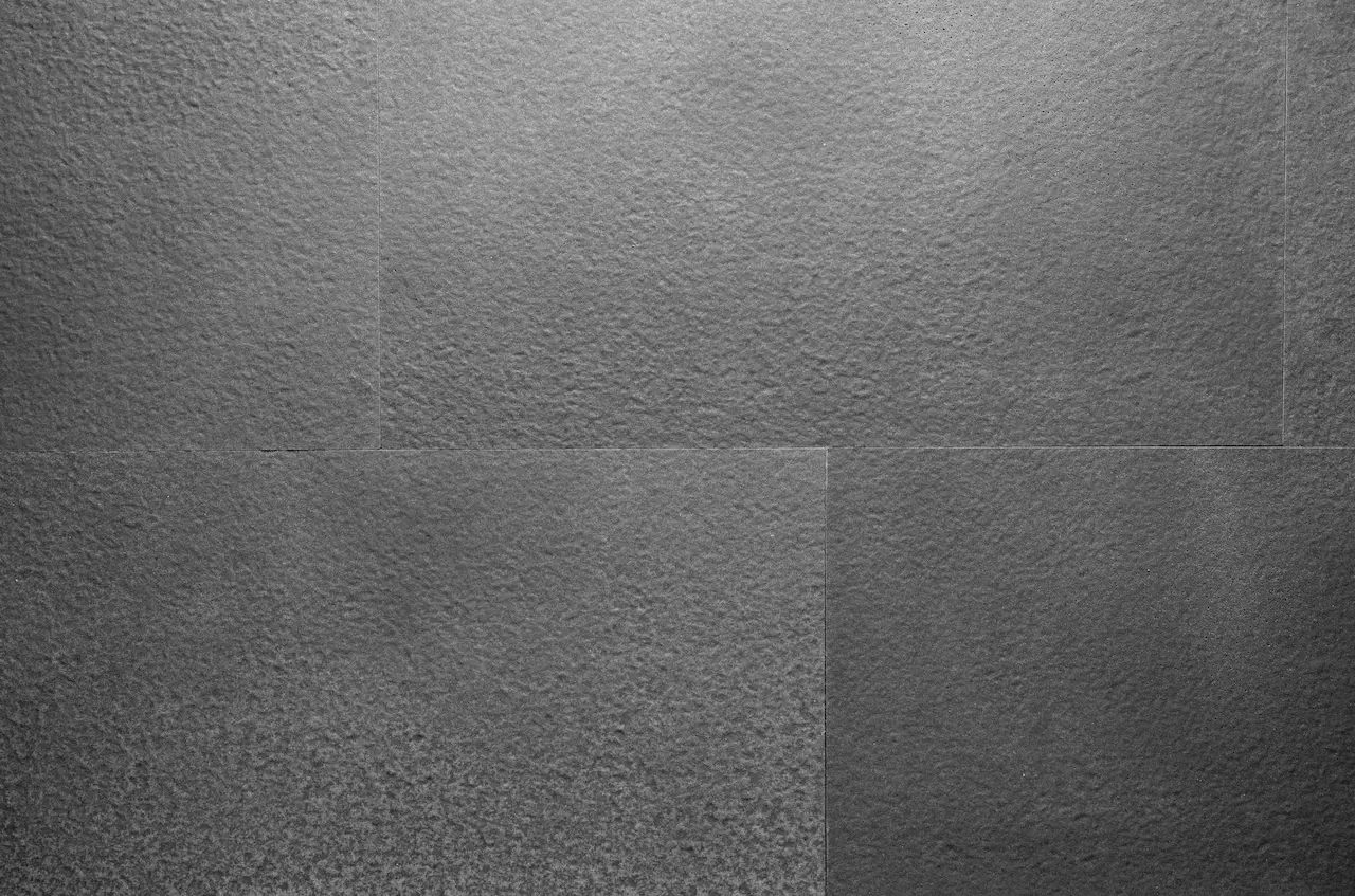 Light-grey B04 Butcher Light Gray flexible tiles with a bush-hammered texture and white granules